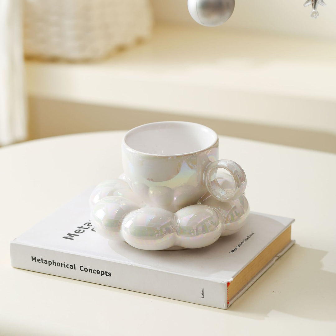 Ceramic mug with sculptural bubble saucer