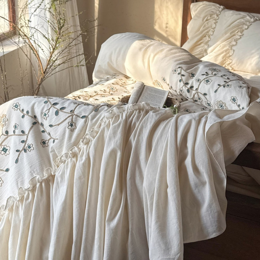 Bedding set with floral embroidered cover, gathered ruffle and cotton texture