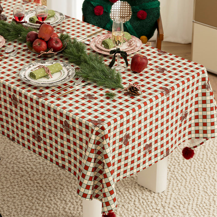 Checked flannel tablecloth with pom-pom tassels and traditional tartan pattern