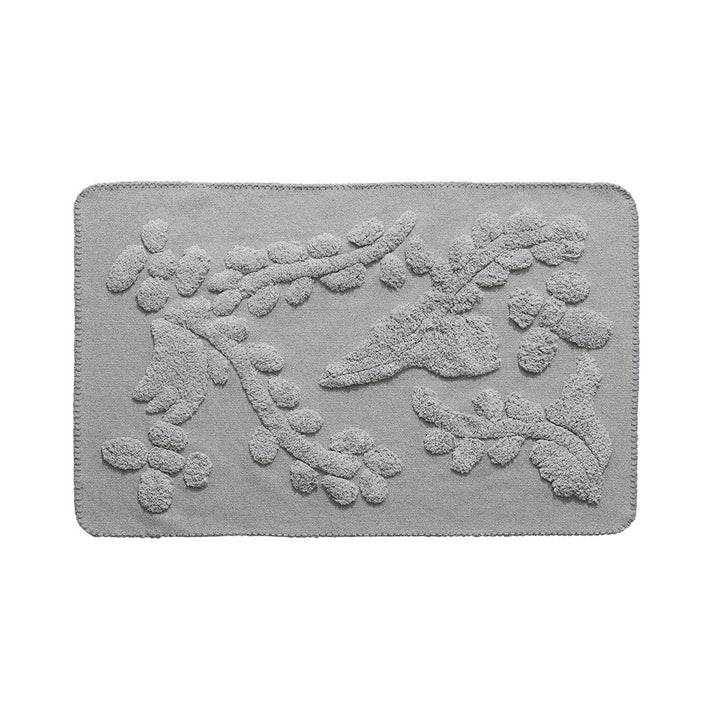 Rectangular cotton bath mat with abstract 3D tuft relief and non-slip back