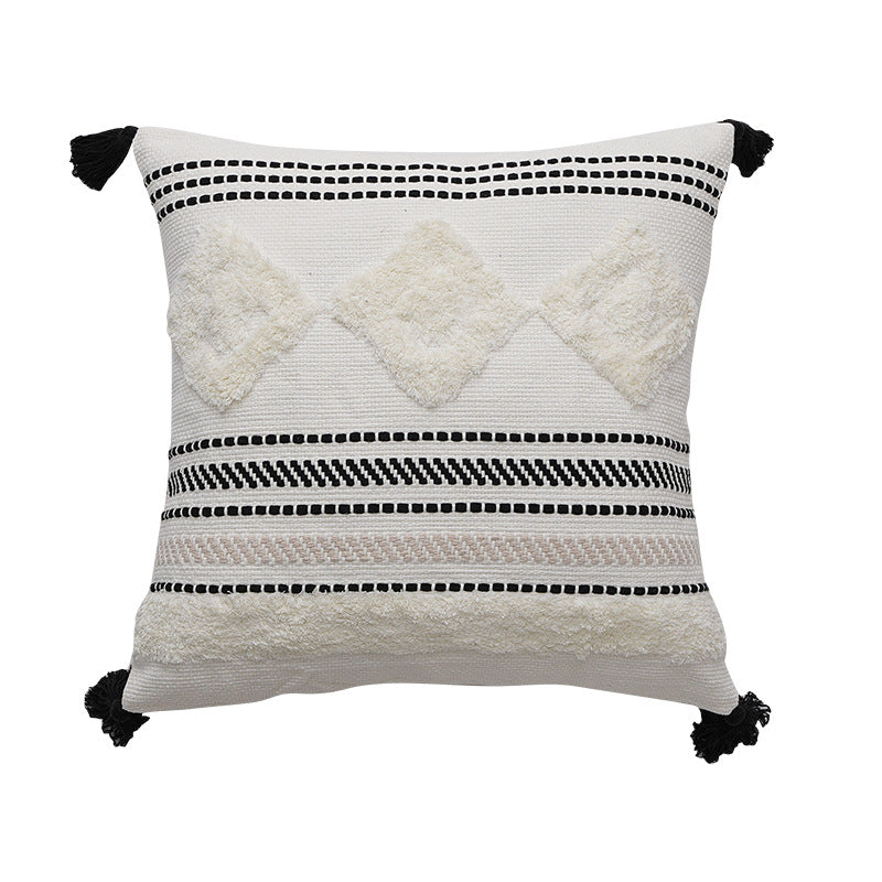 Decorative cotton cushion with pompom and woven ethnic relief