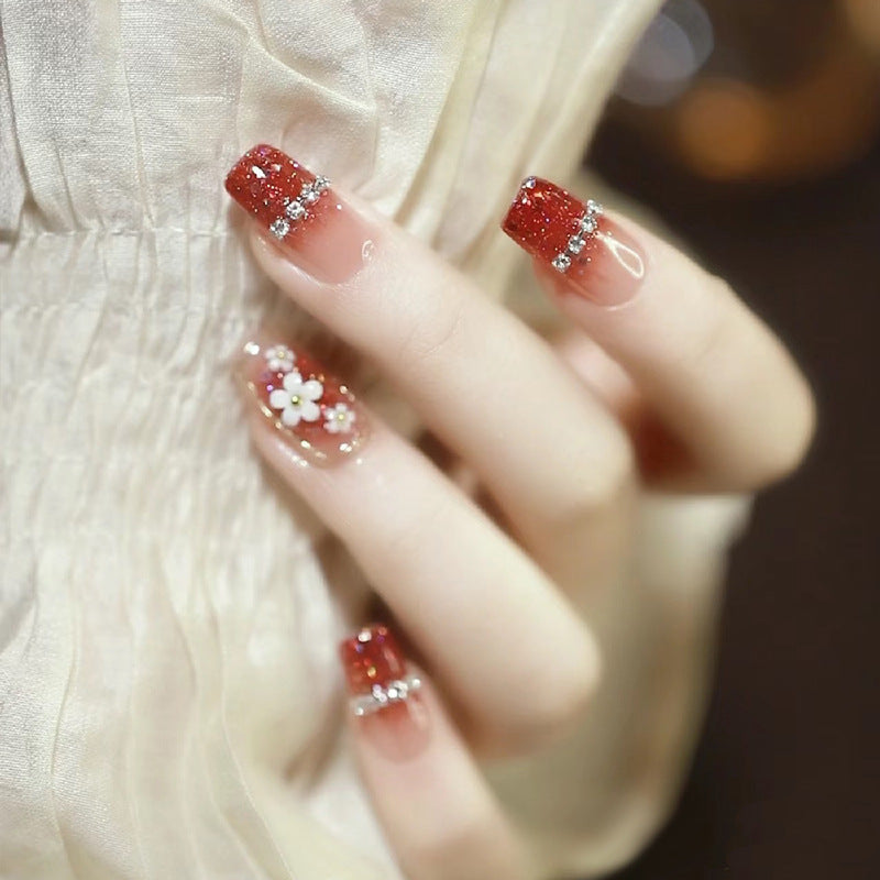 Artistic Press-On Nail Art with Floral and Glitter Accents Kalsten