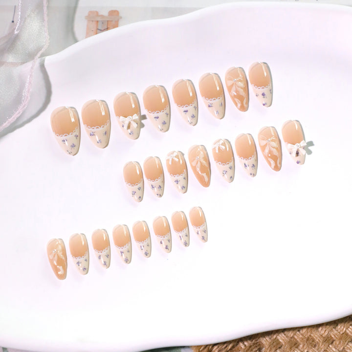 Artful nail art with elegant bows and rhinestone details Kalsten
