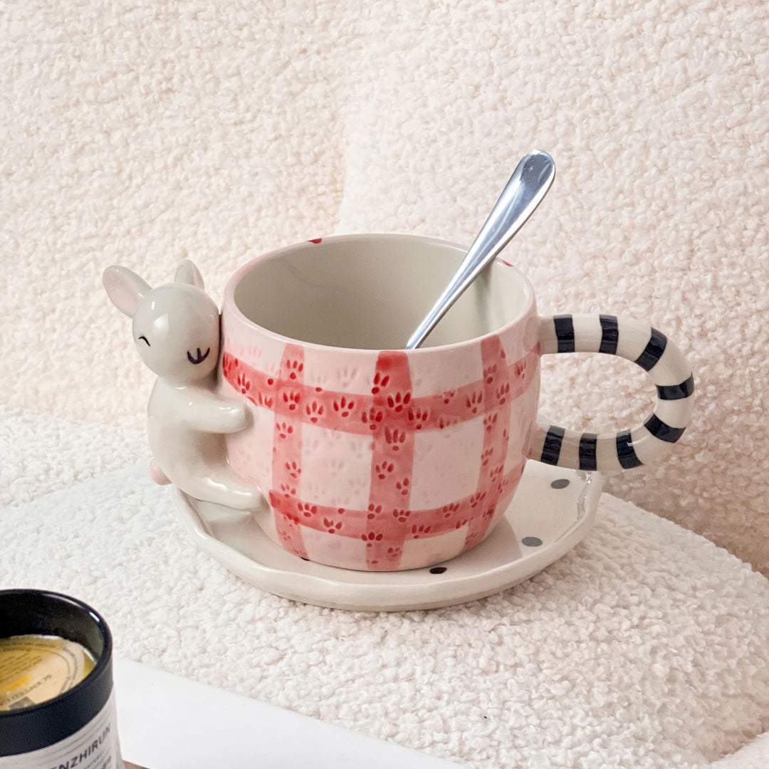 Playful ceramic cup set with koala relief handle and matching saucer