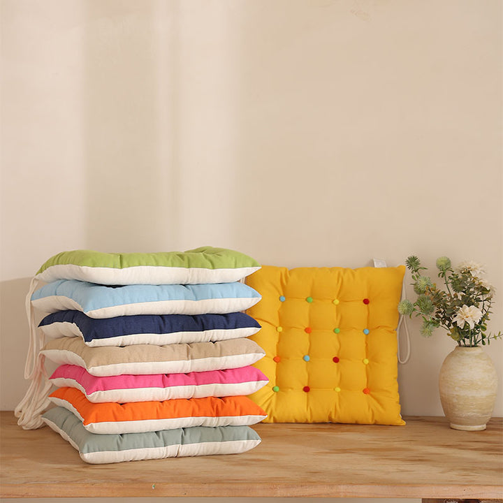 Padded quilted seat cushion with colorful button applications and non-slip underside Kalsten