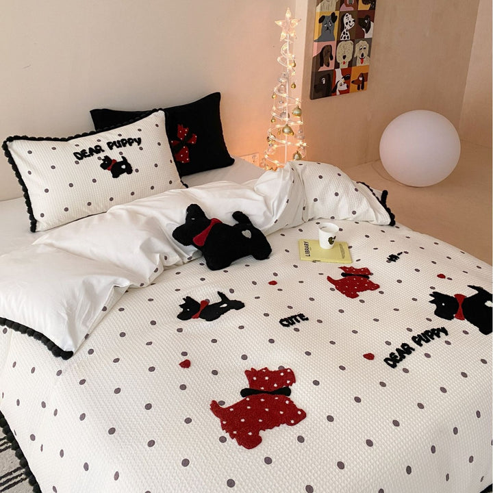 Quilted bedspread and pillow set with embroidered puppy motifs