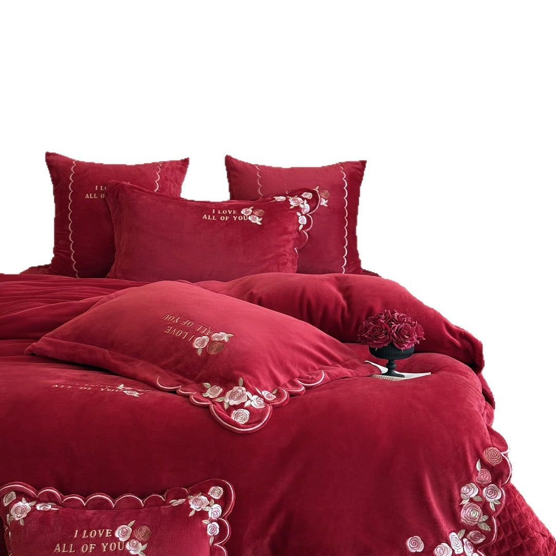 Soft-touch bedding set with floral rose embroidery, wavy hem, and reversible pillow.