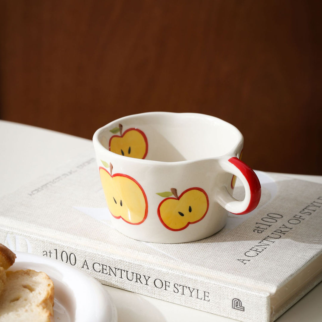 Ceramic mug with hand-painted banana illustration and round handle