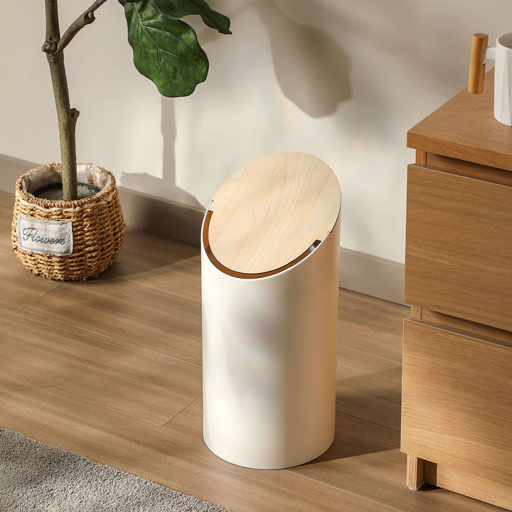 Modern oval waste bin with rotating wooden lid and noise-dampening opening