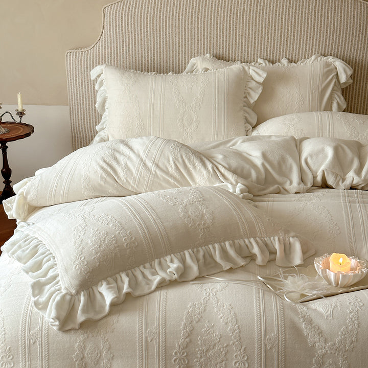 Quilted bedding set with ruffle and medallion relief