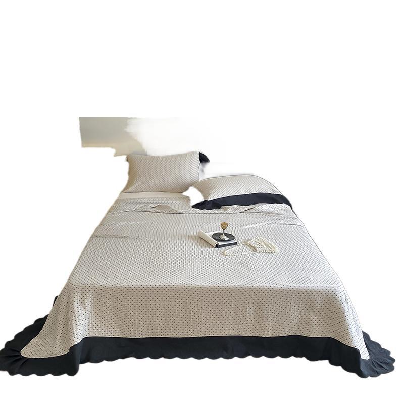 Quilted bedspread and pillowcase set with waffle texture and contrasting ruffle