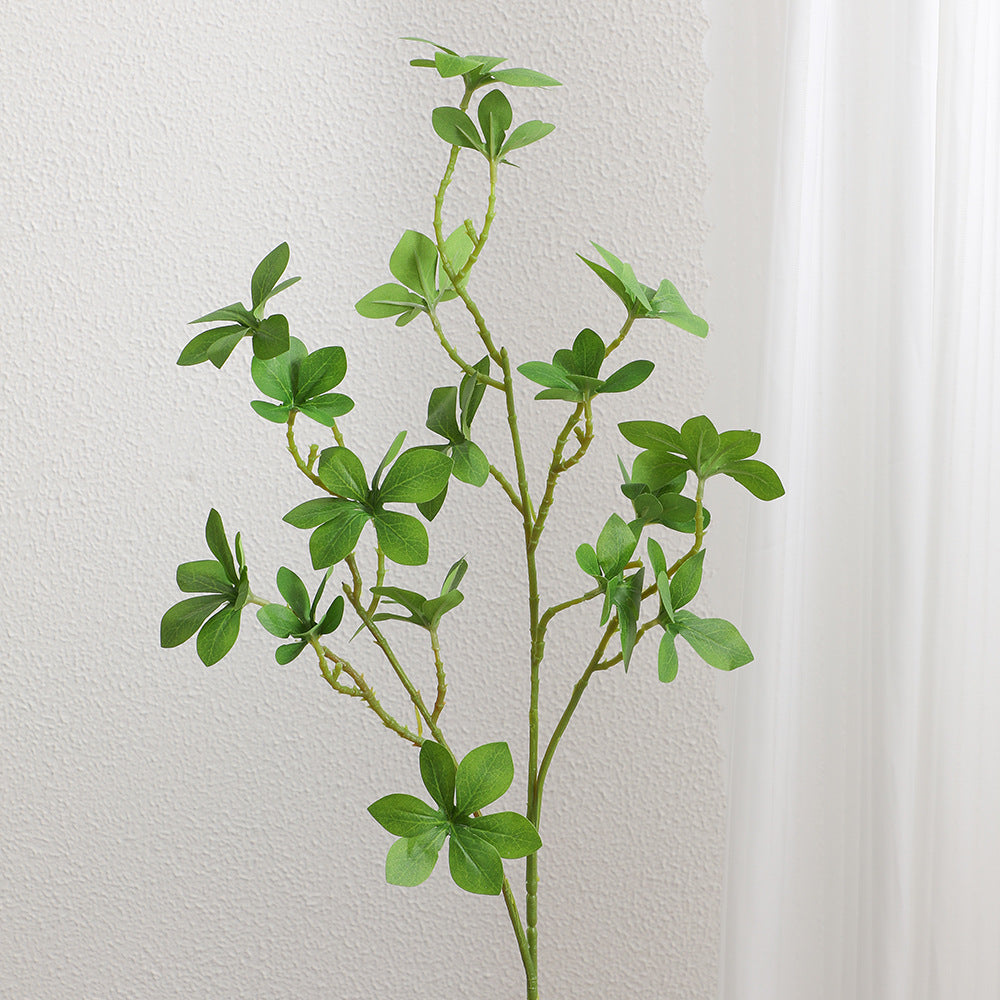 Decorative artificial branch with vibrant leaves