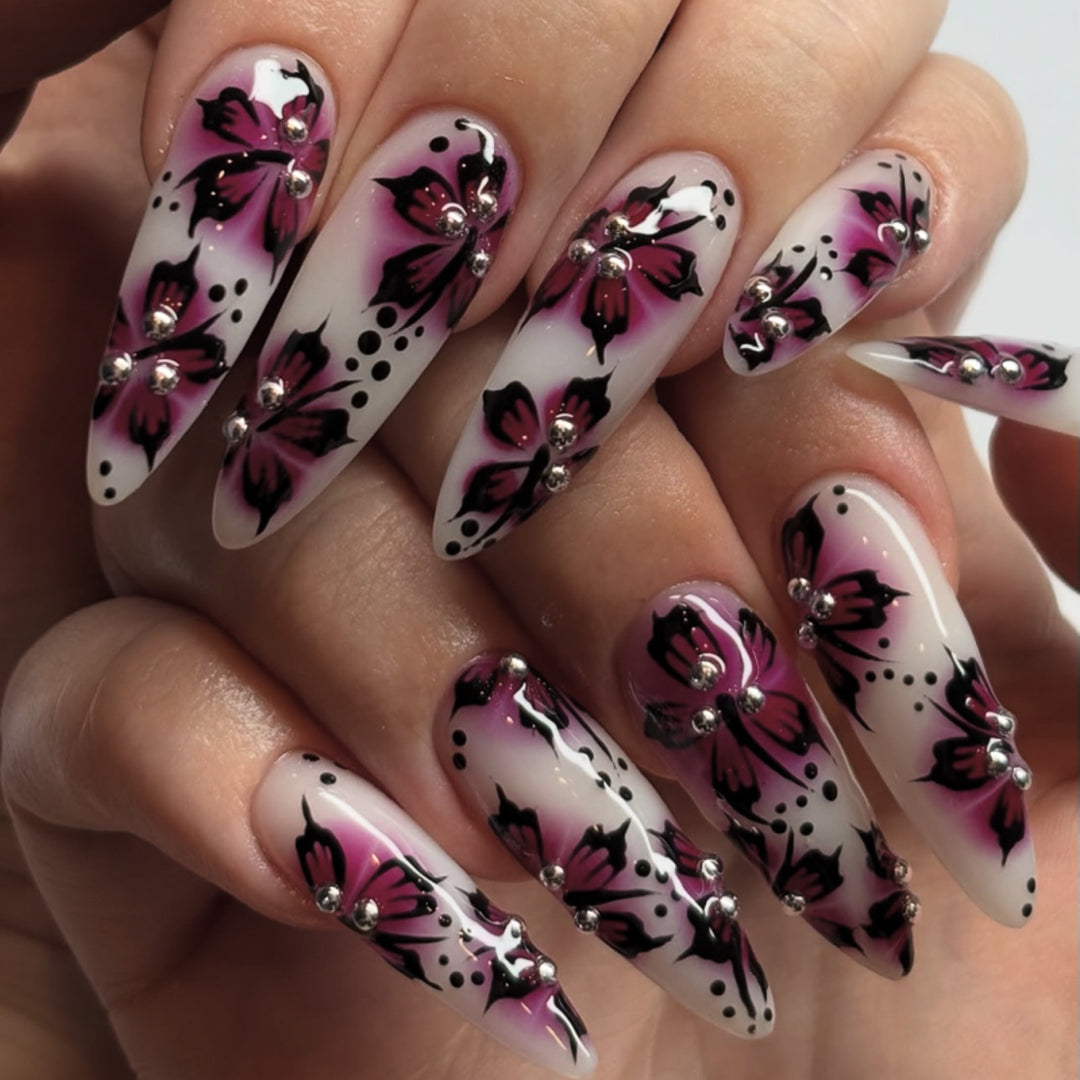Artful nail art with floral design and rhinestone accents Kalsten