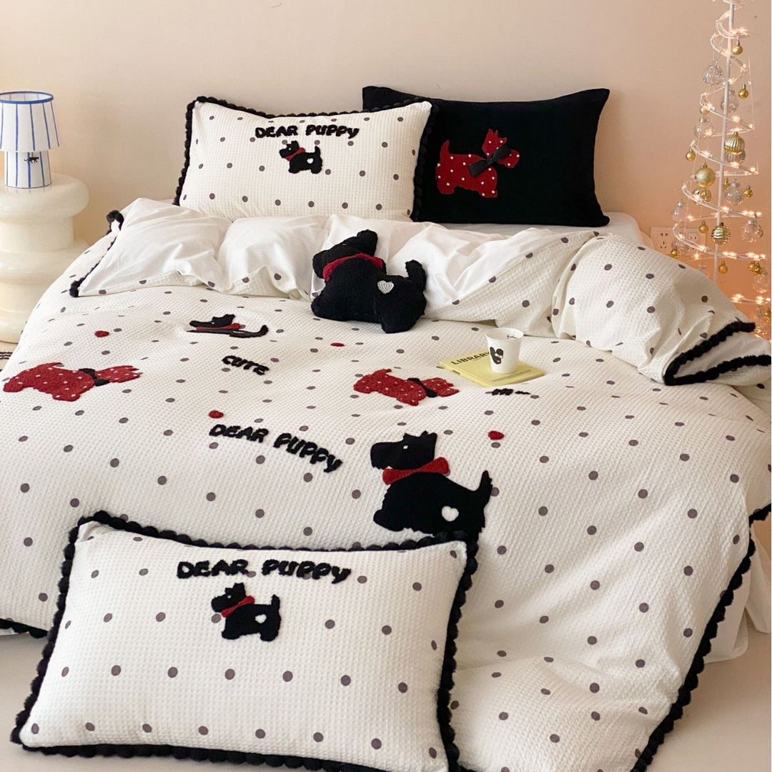 Quilted bedspread and pillow set with embroidered puppy motifs