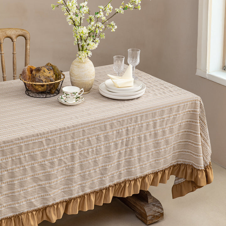 Rustic country house tablecloth made of cotton blend fabric with fine check pattern and ruffled hem