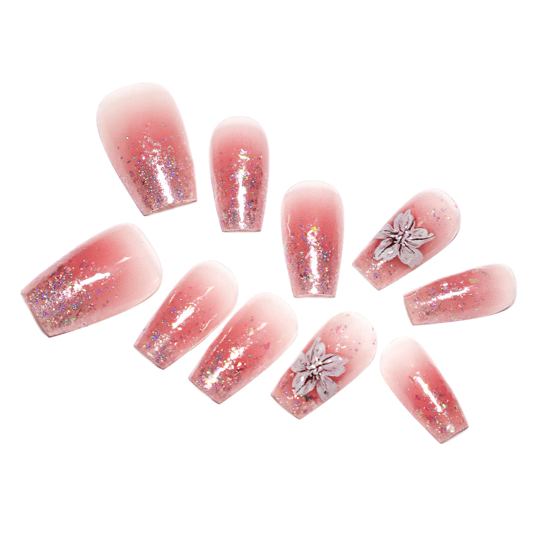 Artificial nail extensions with floral design and glitter accents Kalsten