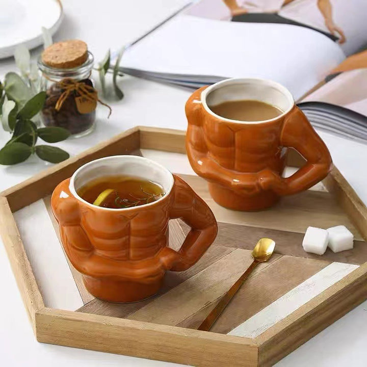 Ceramic mug in torso shape with muscular body and ergonomic handle