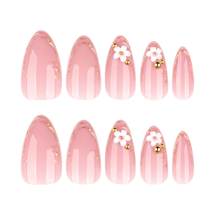Artful nail design with golden accents and floral details Kalsten