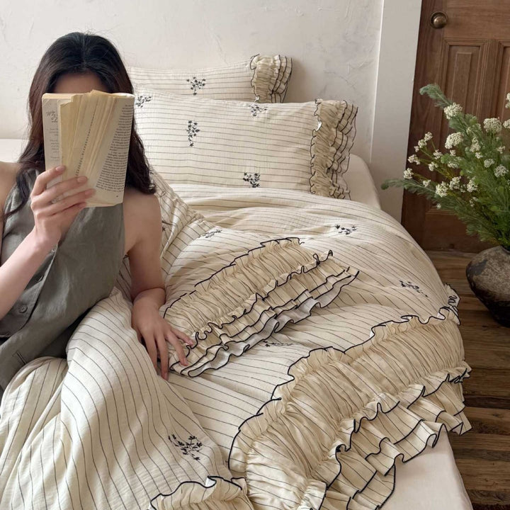 Romantic bedding set with ruffle, fine floral embroidery and pinstripes