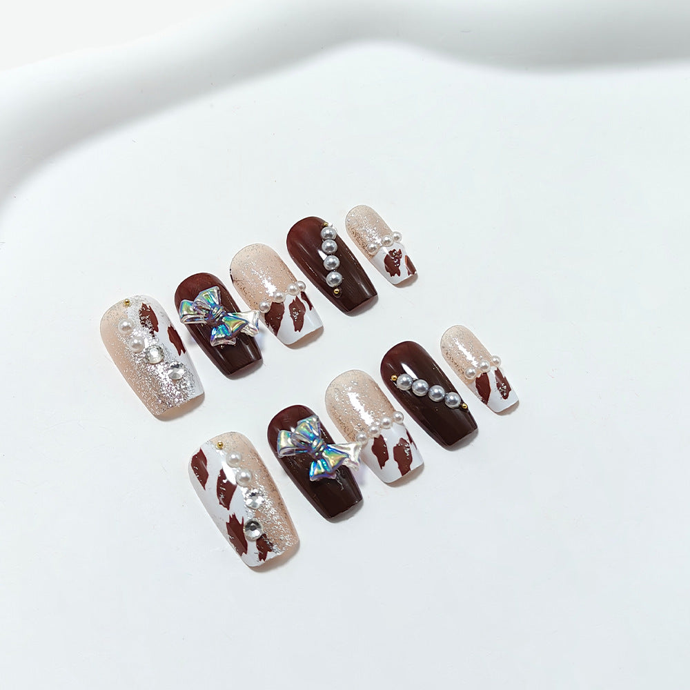 Artificial nails with glamorous rhinestone and bow design Kalsten