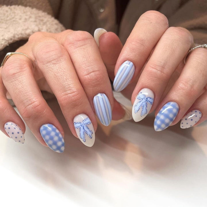 Artful Nail Art with Flower Design and Blue French Tip Kalsten