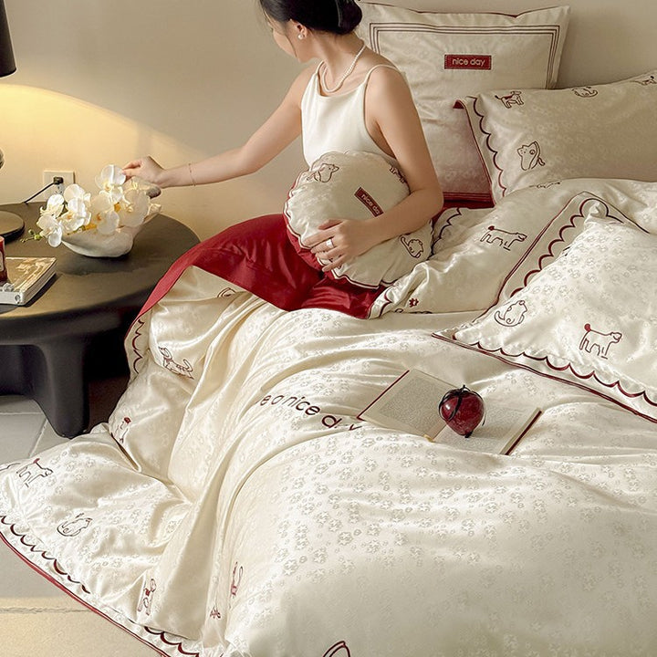 Satin bed linen set with shiny finish, featuring a two-color reversible function and animal embroidery