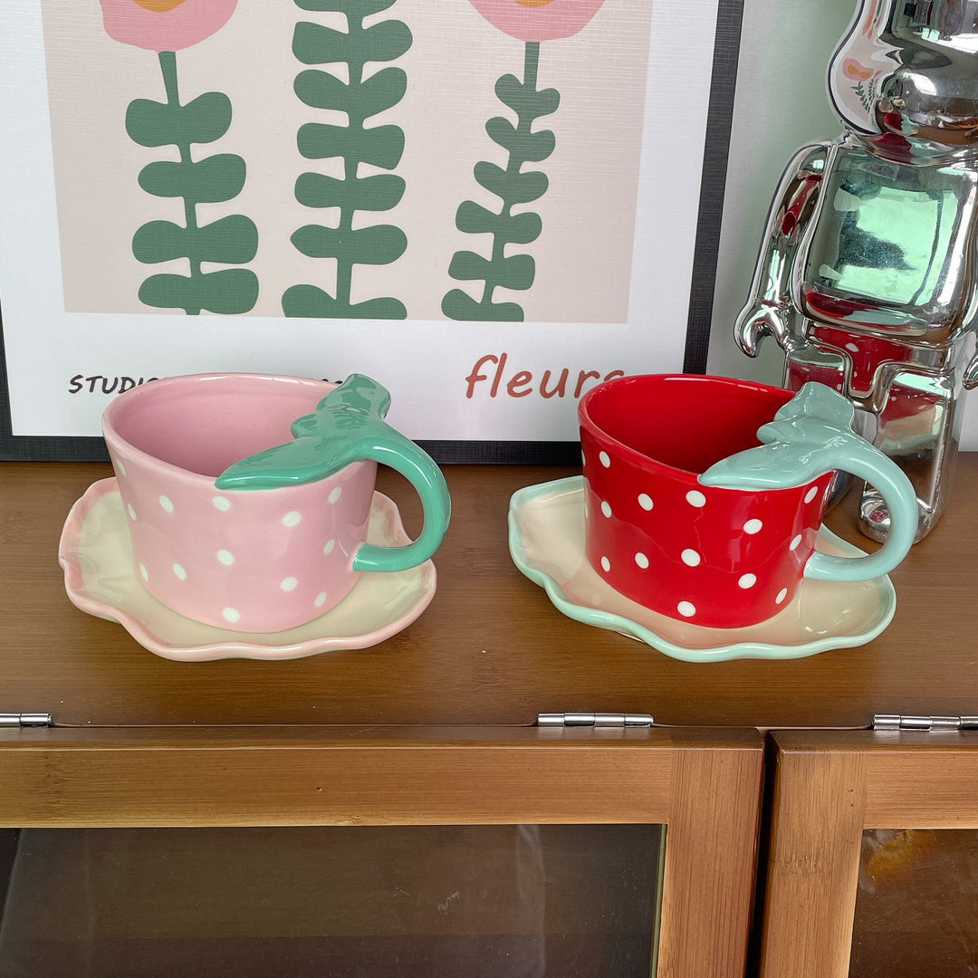 Playful ceramic mug with shaped leaf handle, saucer, and tulip spoon