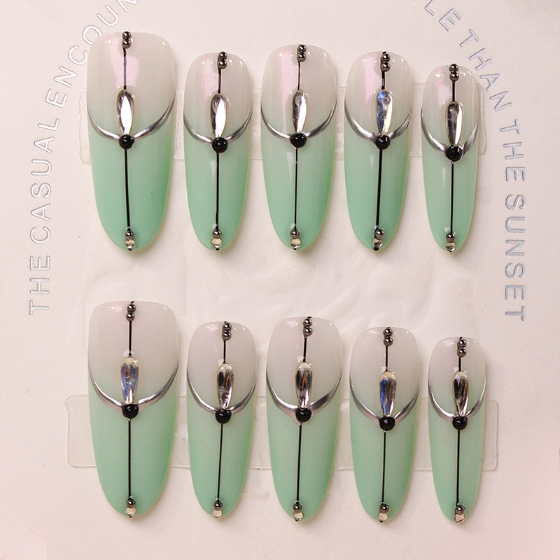 Acrylic nail set with elegant ombre effect and glamorous embellishments Kalsten