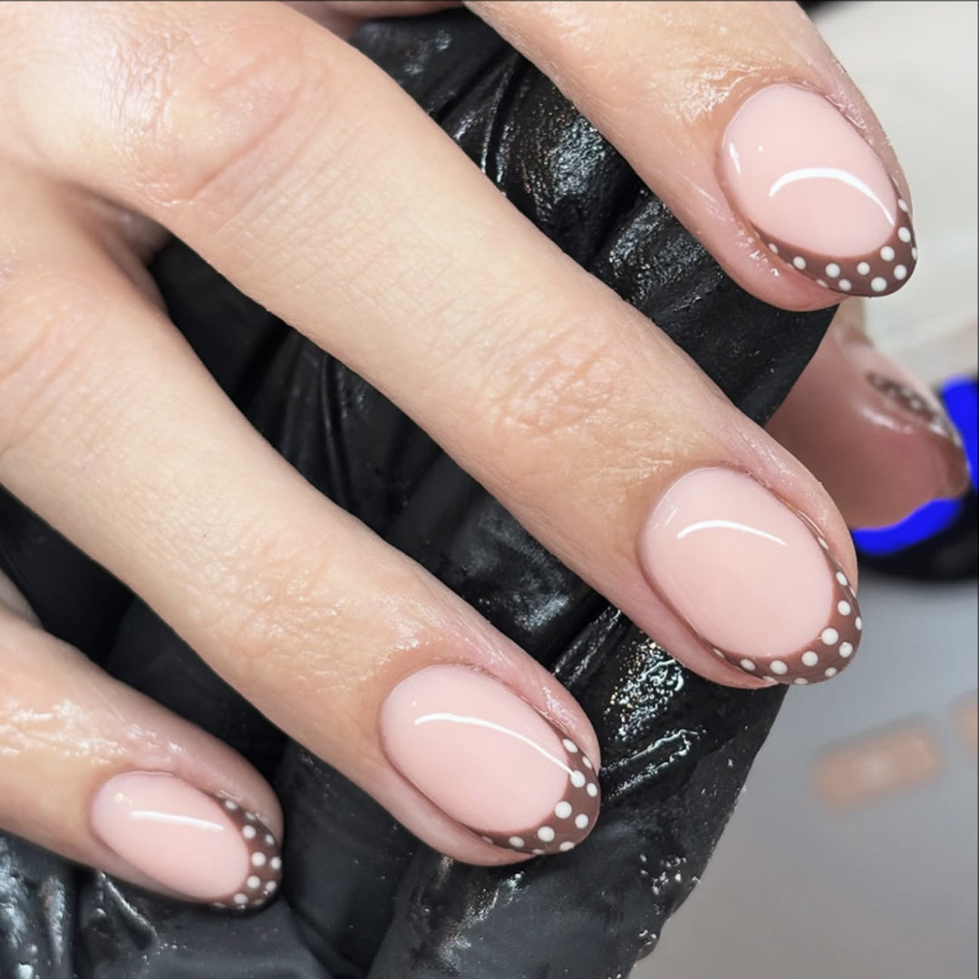 Artful nail design with elegant French tip and accents Kalsten