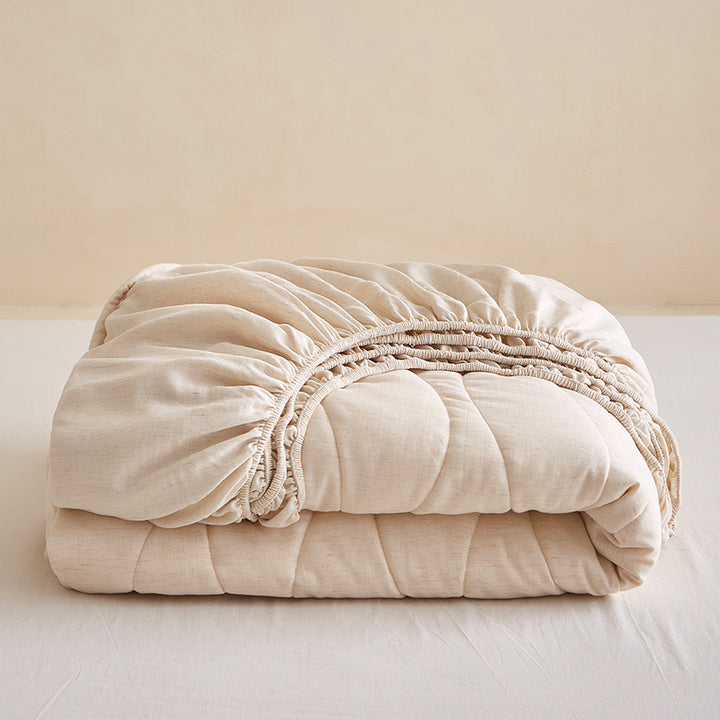 Quilted mattress topper with all-around fitted edge and breathable padding