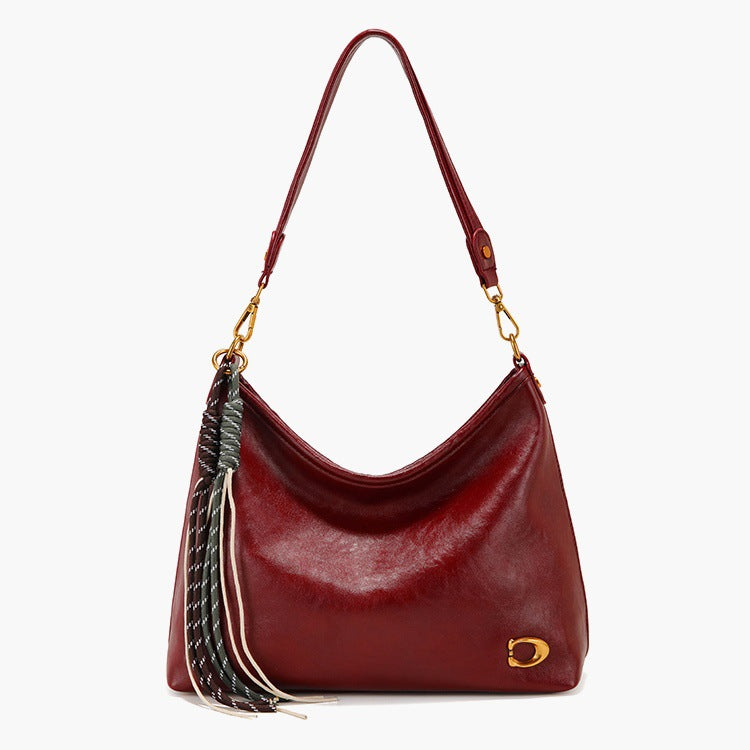 Elegant Hobo Handbag with Decorative Tassels