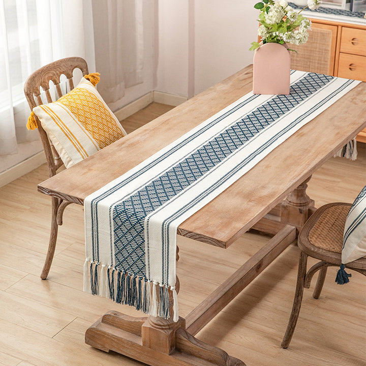 Handwoven cotton table runner with geometric center stripe and fringes
