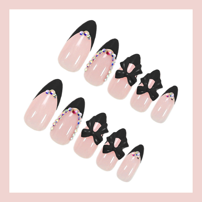 Artificial nail set with glamorous bow design and sparkling accents Kalsten