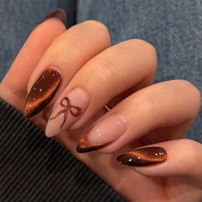 Glamorous artificial nail set with glitter effects and elegant bow motifs Kalsten