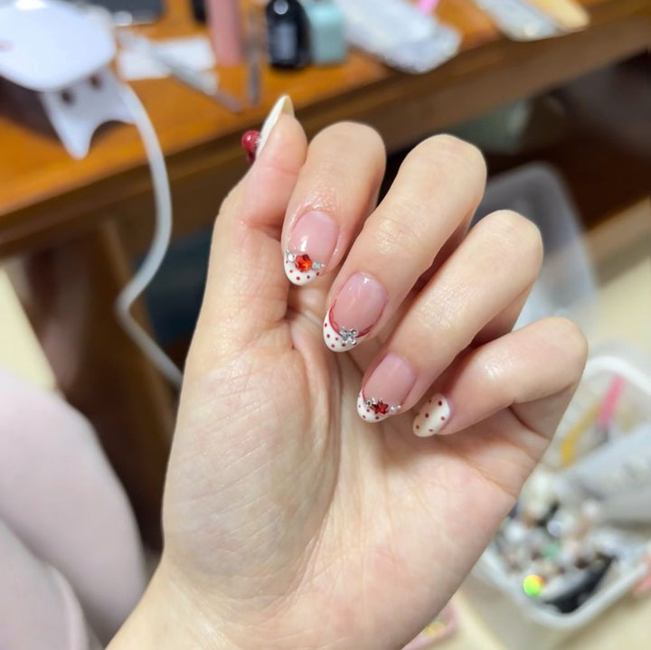 Elegant French Tip Nail Art Extensions with Decorative Accents