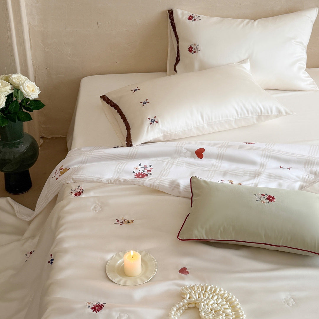 Elegant satin bedding set with fine floral embroidery and lace trim