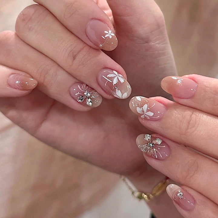 Artful nail design with floral pattern and glitter accents Kalsten
