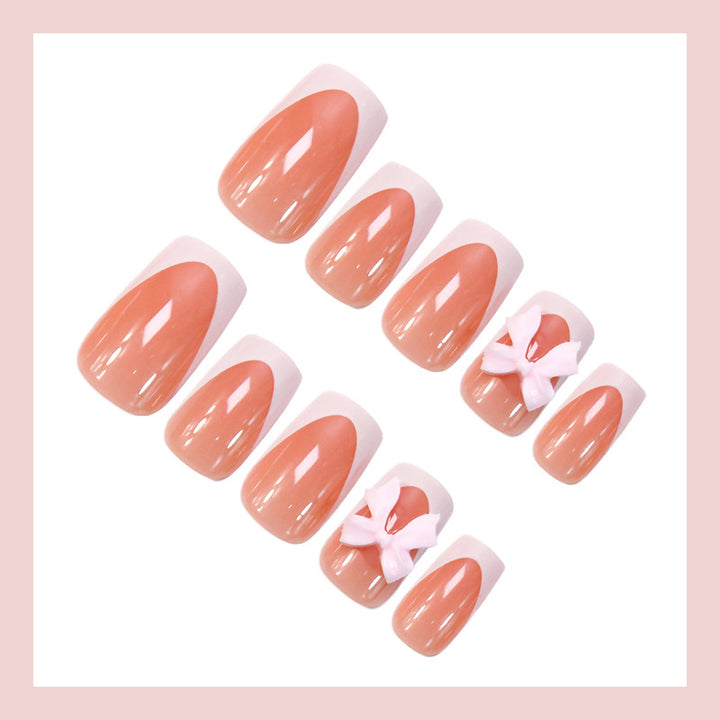 Acrylic nail set with elegant tips and playful bows Kalsten