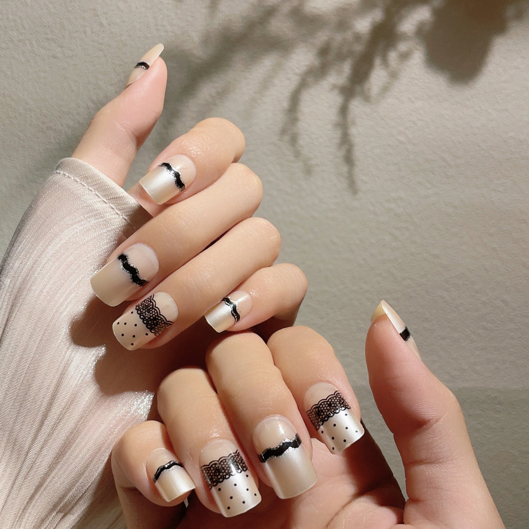 Artistic Press-On Nail Design with Lace and Polka Dots