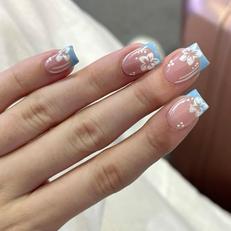 Artful Nail Art with Flower Design and Blue French Tip Kalsten