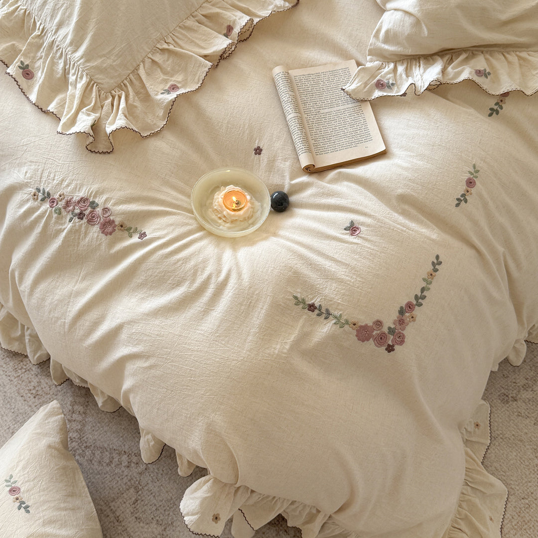 Bedding set in natural linen style with delicate rose garland embroidery and ruffled trim