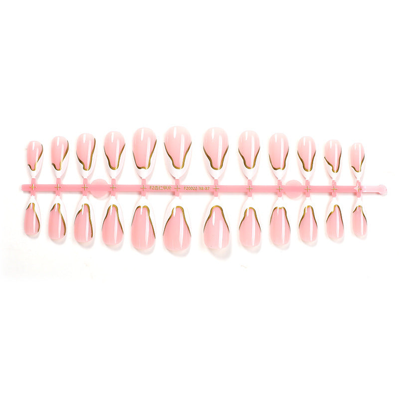 Artifical nail set with elegant gold trim and delicate pink Kalsten