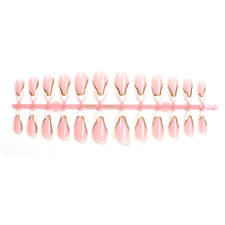 Artifical nail set with elegant gold trim and delicate pink Kalsten