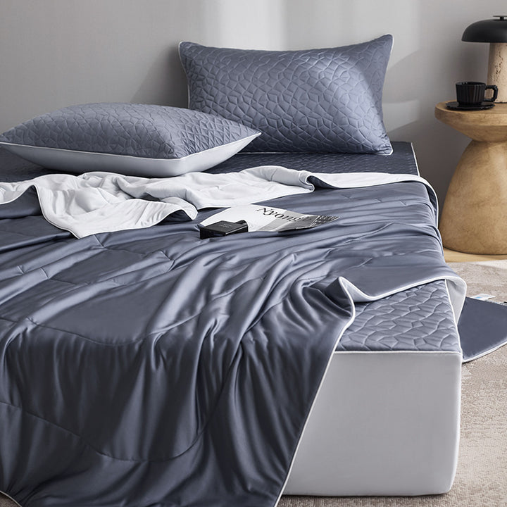 Quilted bedding set with reversible satin blanket and mattress protector
