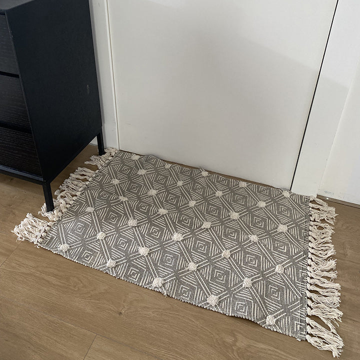 Handwoven cotton runner with pompom tufting and decorative fringes