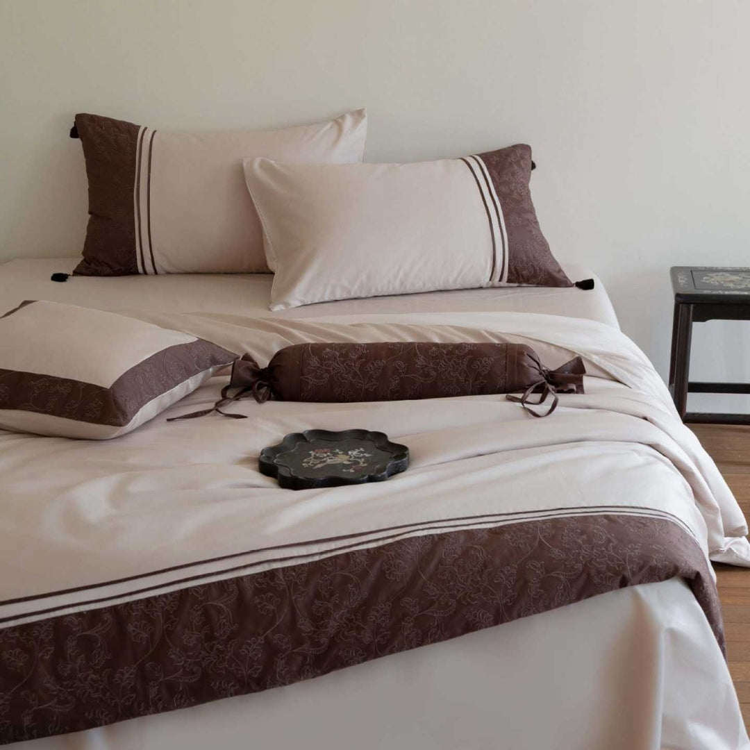 Luxurious cotton satin bedding set with decorative borders and decorative pillows