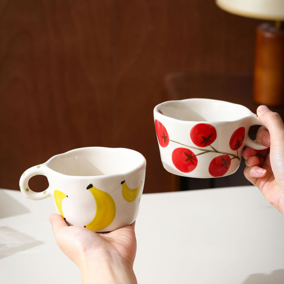 Ceramic mug with hand-painted banana illustration and round handle