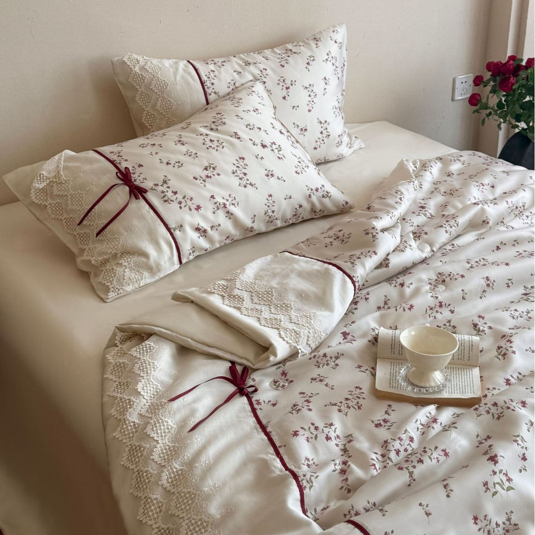 Luxurious cotton satin duvet cover set with lace trim, floral all-over embroidery, and decorative ribbons