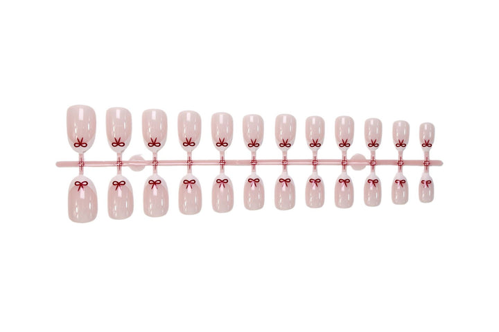 Artificial nail set with romantic bow motifs and French design Kalsten