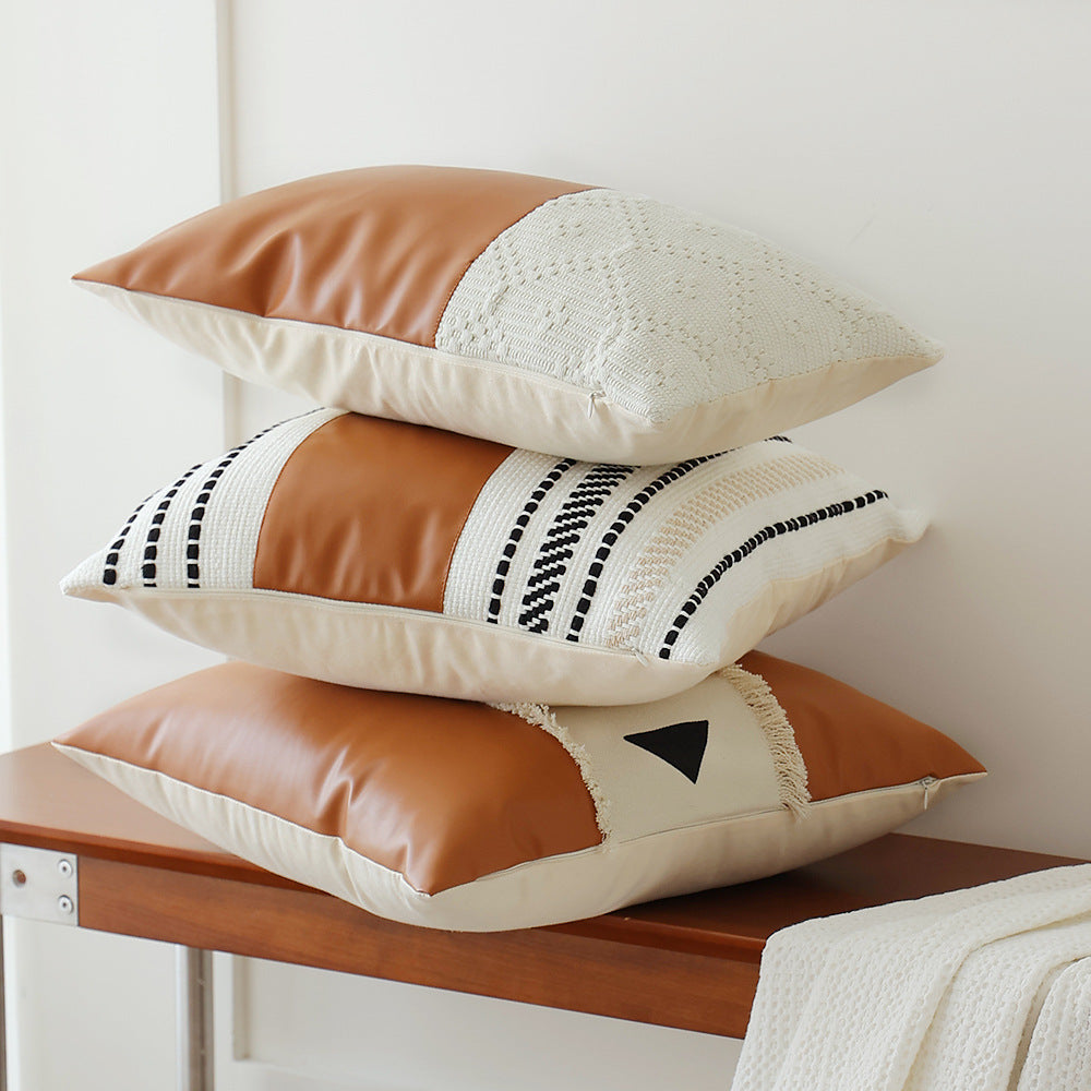 Square faux leather decorative cushion with woven central stripe and fringes